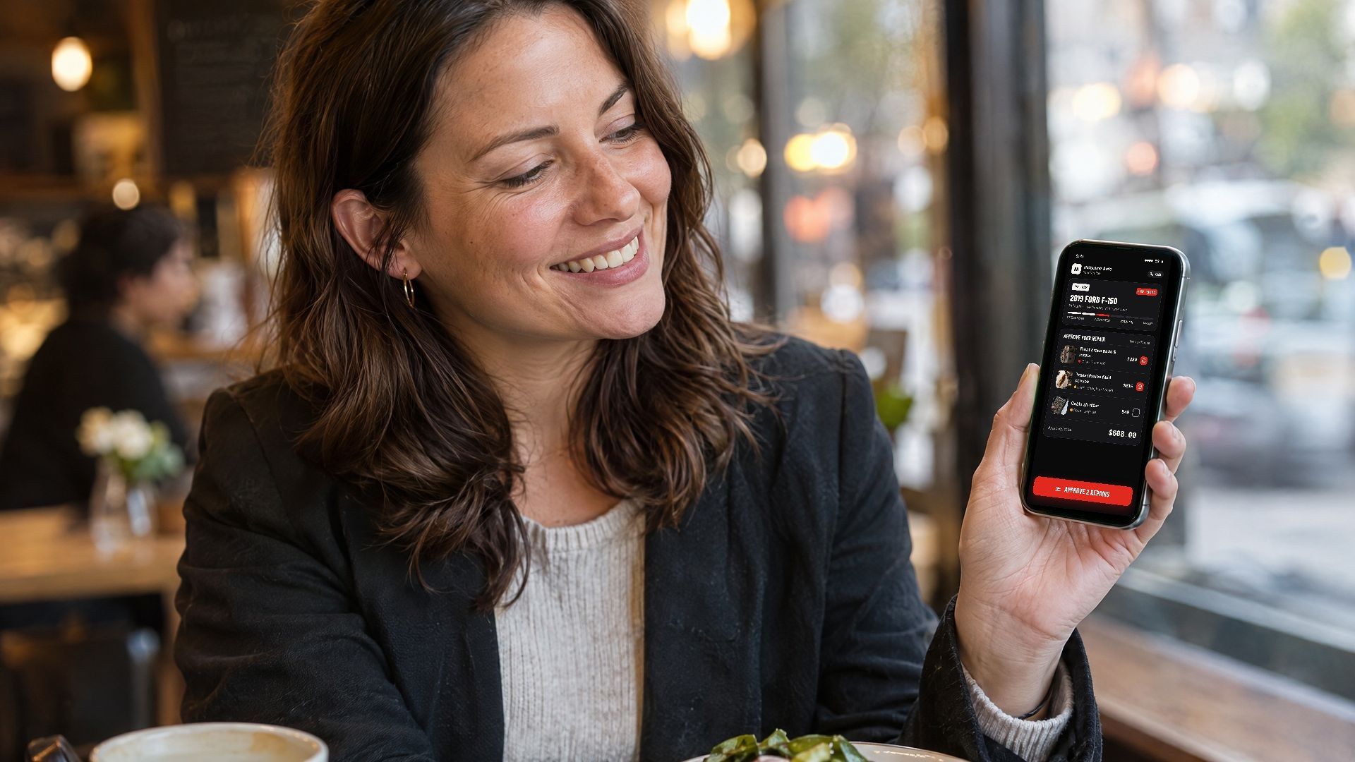 Customer approving her repair on her phone during lunch